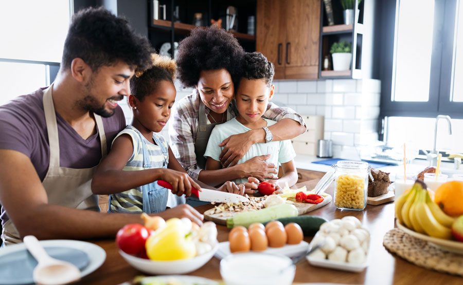 Family of four cooking together